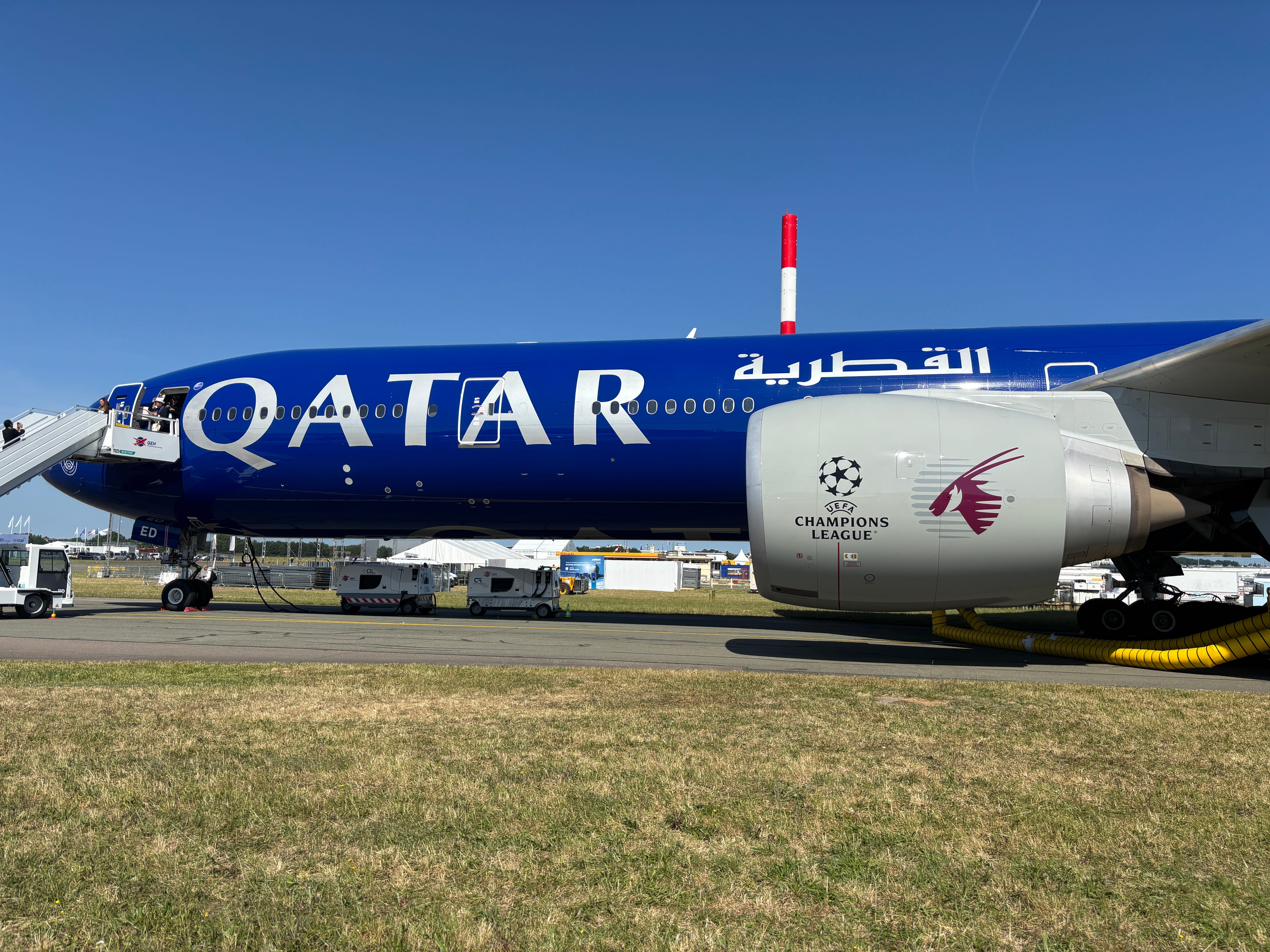 A side view of a Qatar Airways Boeing 777 in the PSG Champions League livery at the 2025 Paris Air Show