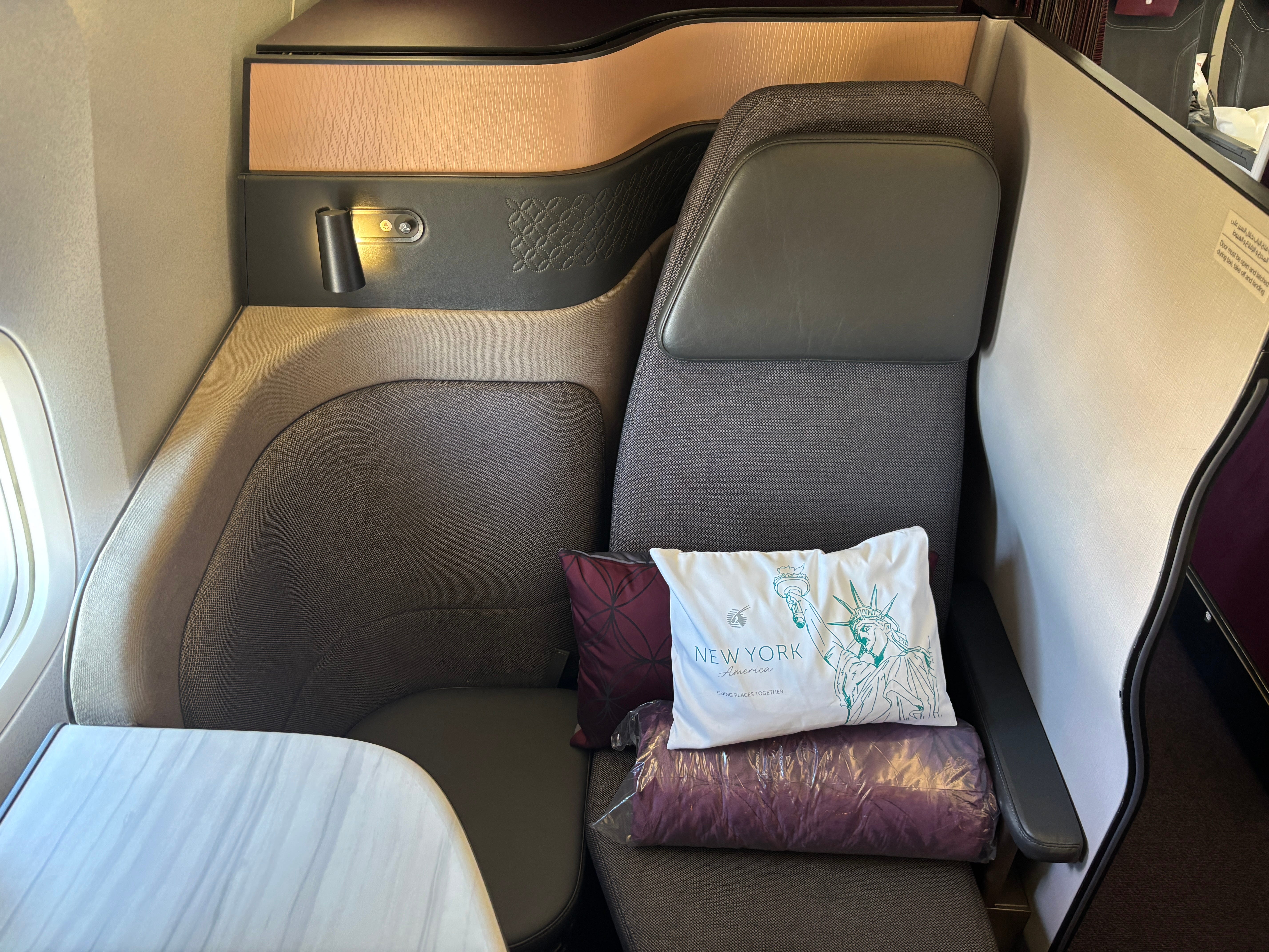 A front-view of a QSuite on a Qatar Airways Boeing 777