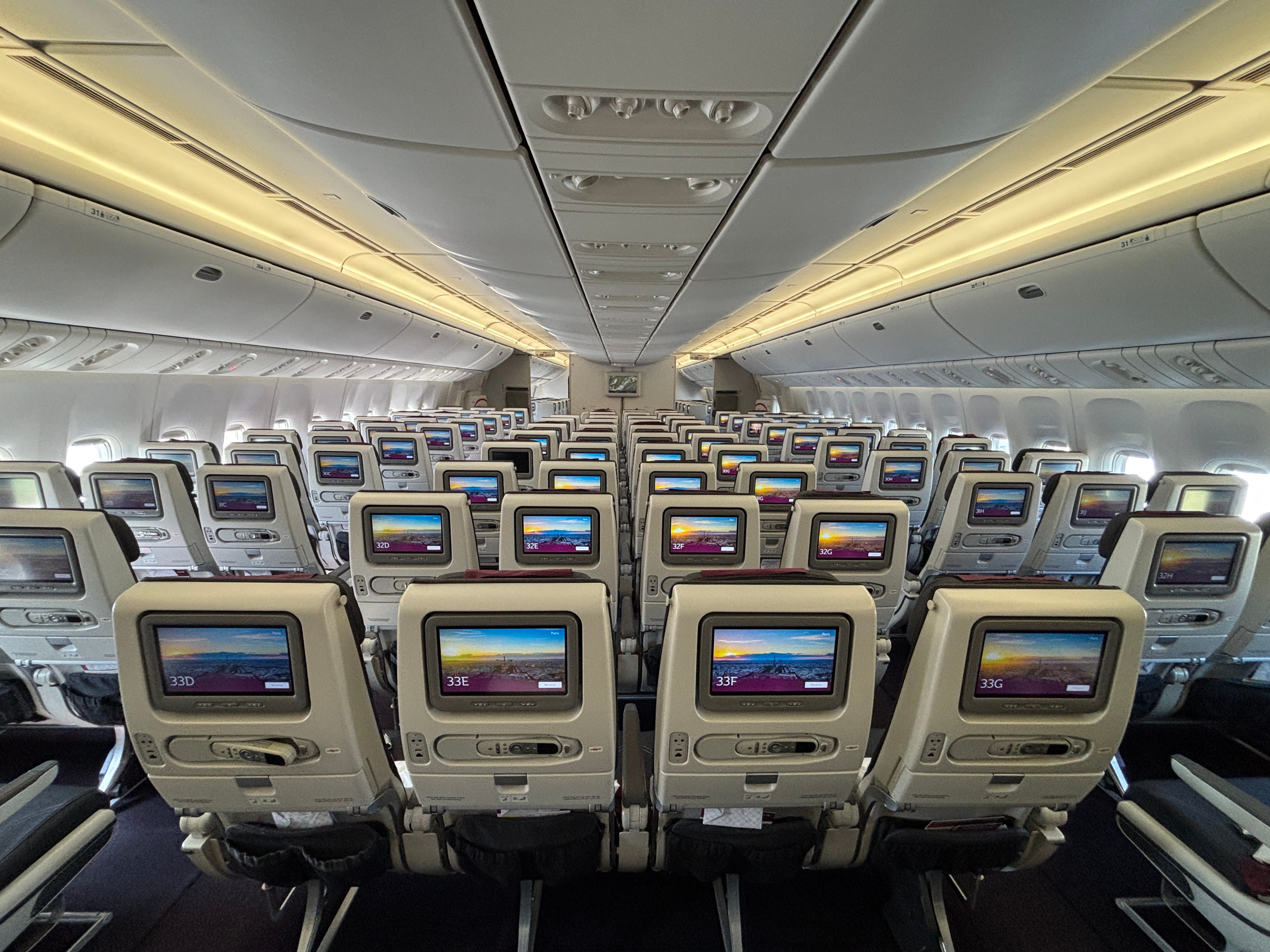 The economy cabin as seen from the rear, of a Qatar Airways Boeing 777