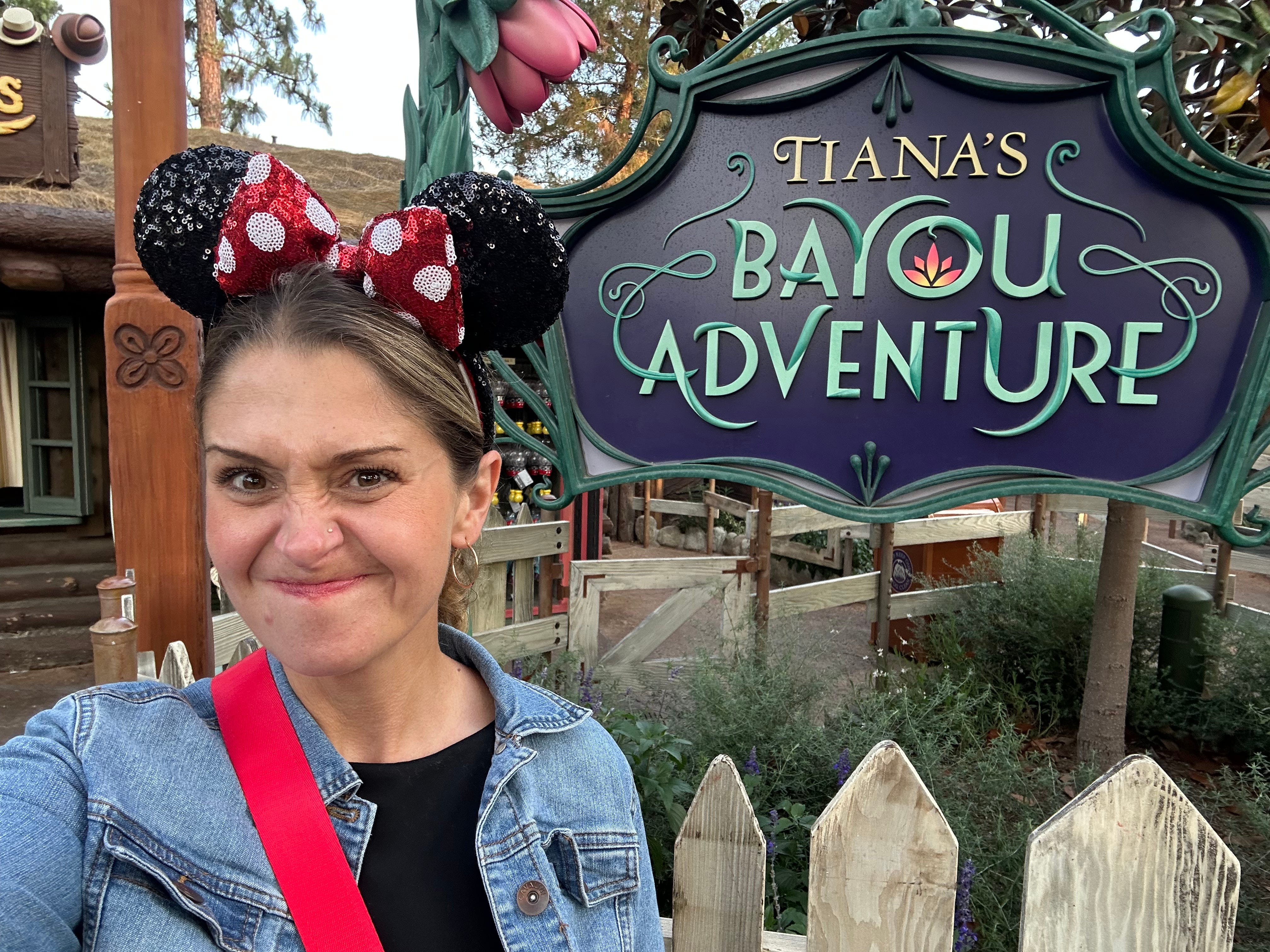 The author standing in front of Tiana's Bayou Adventure Ride at Disneyland.