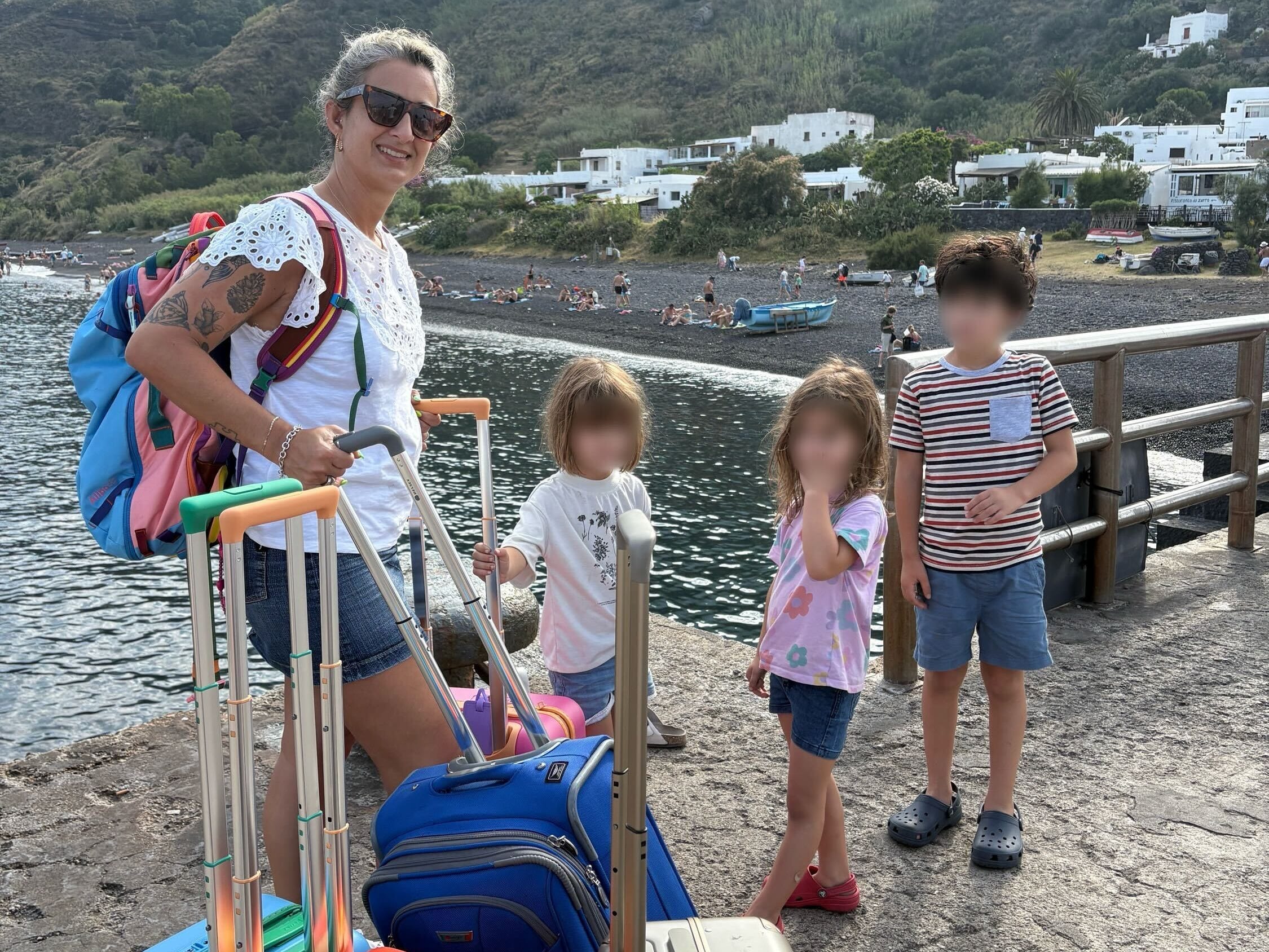 Mom with kids and carry ons.