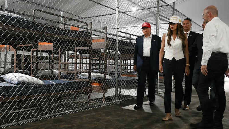 US President President Donald Trump (L), Florida Governor Ron DeSantis (2nd-R), and Secretary of Homeland Security Kristi Noem (2nd-L) tour a migrant detention center, dubbed "Alligator Alcatraz," located at the site of the Dade-Collier Training and Transition Airport in Ochopee, Florida on July 1, 2025. President Trump is visiting a migrant detention center in a reptile-infested Florida swamp dubbed "Alligator Alcatraz." Trump will attend the opening of the 5,000-bed facility -- located at an abandoned airfield in the Everglades wetlands -- part of his expansion of deportations of undocumented migrants, his spokeswoman said. (Photo by ANDREW CABALLERO-REYNOLDS / AFP) (Photo by ANDREW CABALLERO-REYNOLDS/AFP via Getty Images).