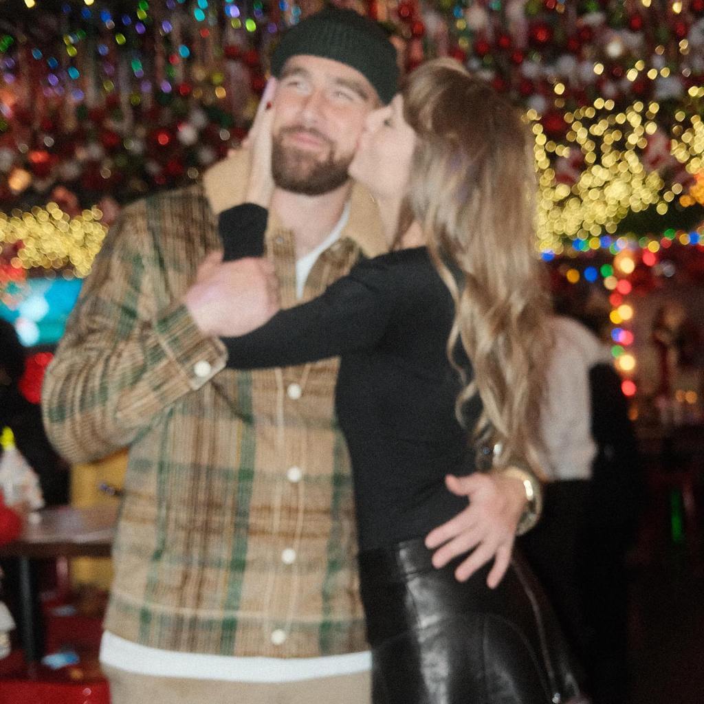 Taylor Swift gives Travis Kelce a smooch on the cheek at a Christmas themed bar