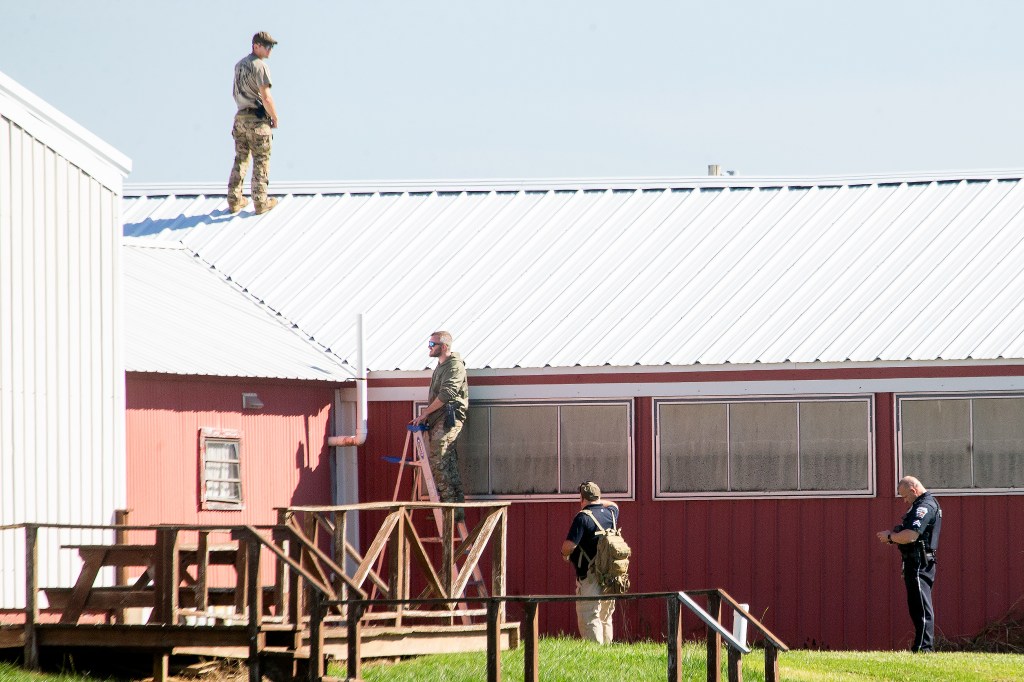 Law enforcement officers surveying a building before a rally.
