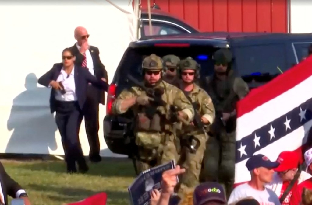 Secret Service agents escorting Donald Trump from a rally after gunfire.