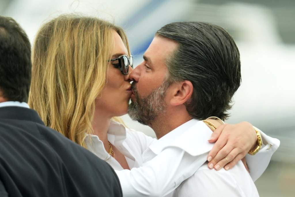 Donald Trump Jr. and Bettina Anderson kissing at Teterboro Airport in New Jersey.