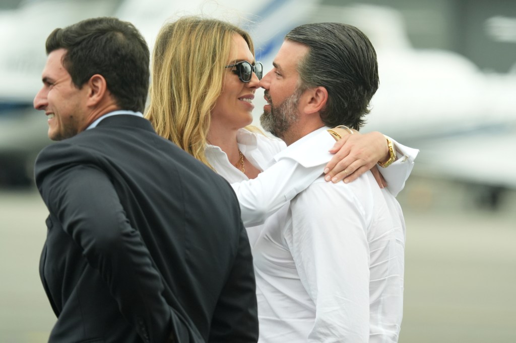 Donald Trump Jr. and Bettina Anderson hugging at Teterboro Airport in New Jersey.
