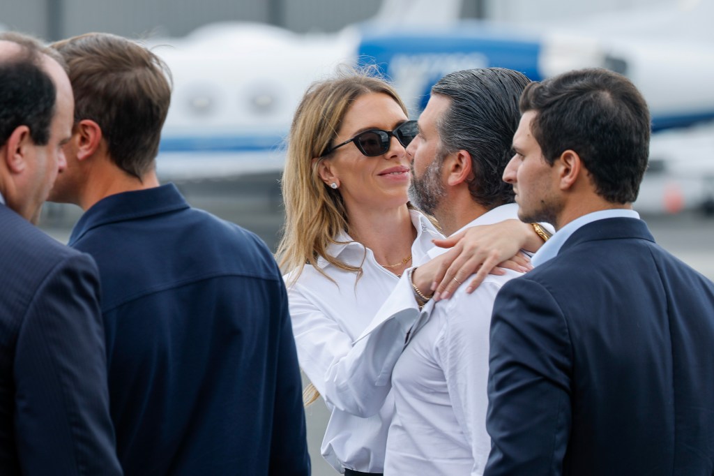 Donald Trump Jr. and Bettina Anderson hugging at Teterboro Airport in New Jersey.