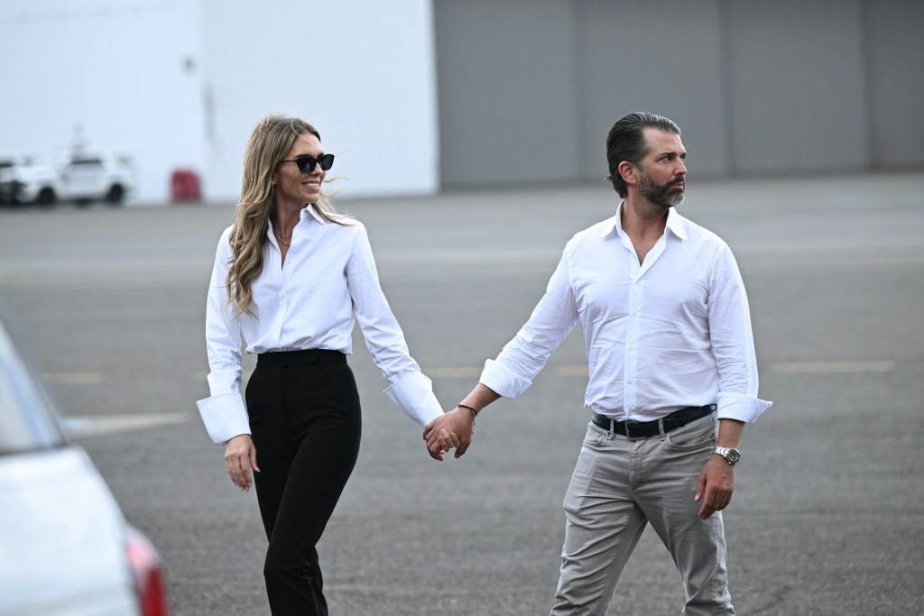 Donald Trump Jr. and Bettina Anderson holding hands at Teterboro Airport in New Jersey.