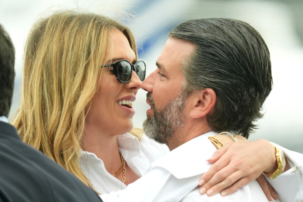 Donald Trump Jr. and Bettina Anderson hugging at Teterboro Airport in New Jersey.