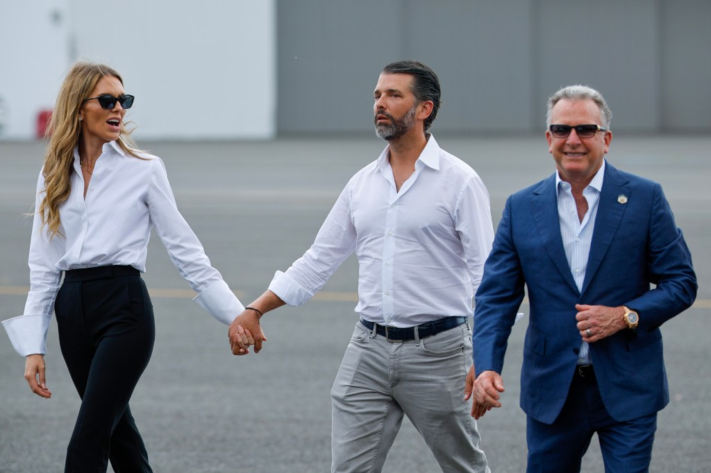 Donald Trump Jr. and Bettina Anderson holding hands at Teterboro Airport in New Jersey.