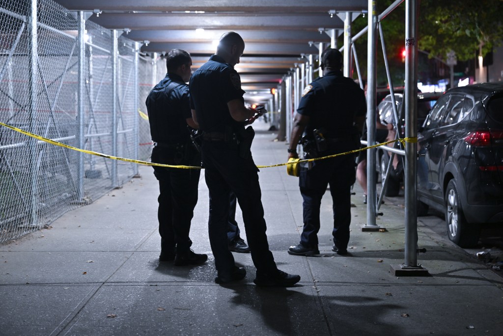 Police officers at a crime scene in Brooklyn.