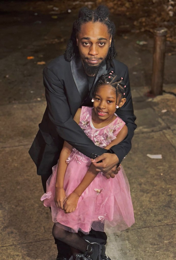 Photo of a man hugging his young daughter.