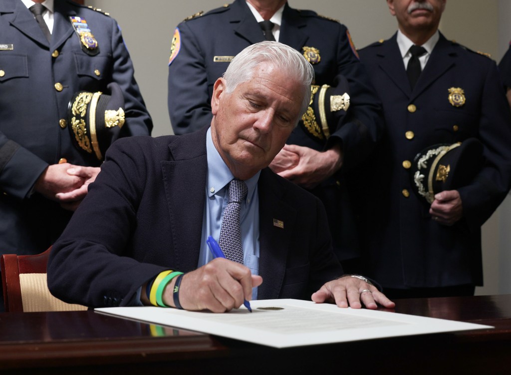 Nassau County Executive Bruce Blakeman signing an executive order.