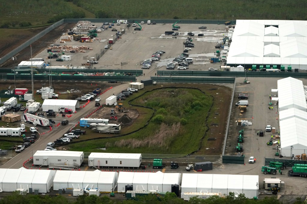 Aerial view of a migrant detention facility under construction.