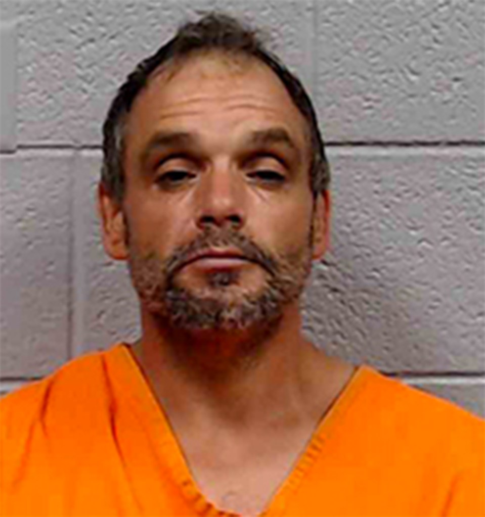 Mugshot of a man in an orange jumpsuit.