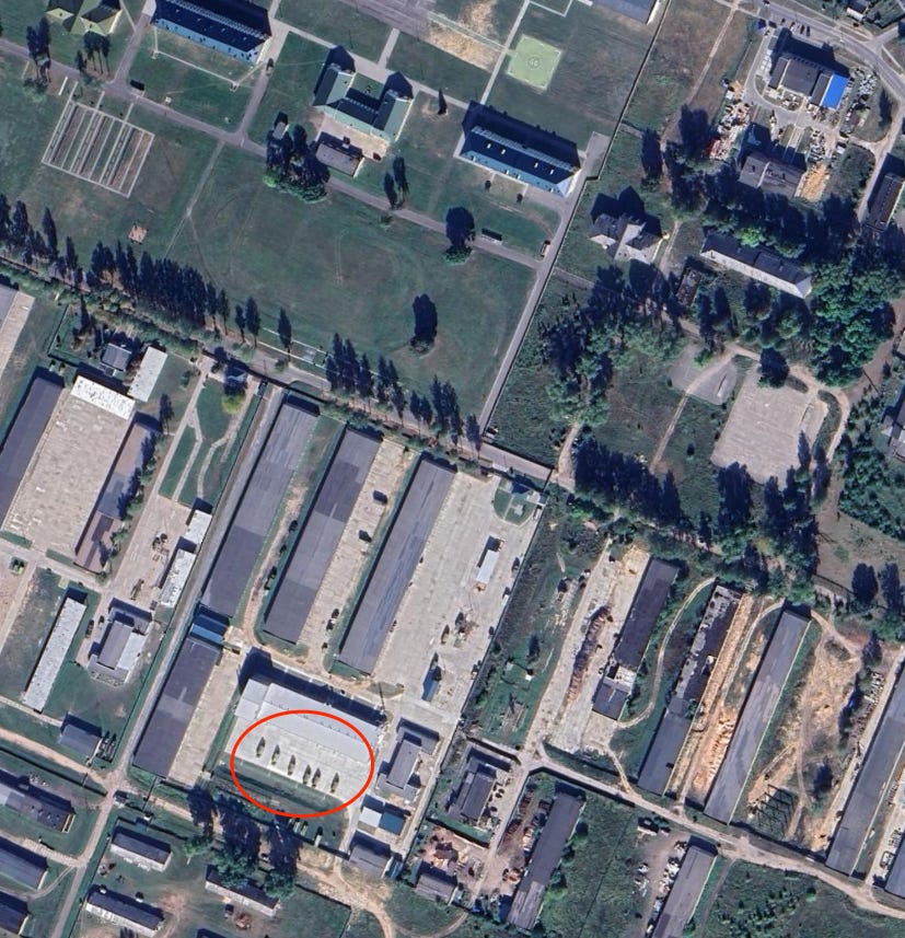 An annotated circle on a Google Earth screenshot shows Iskander missile launchers parked in front of a garage.