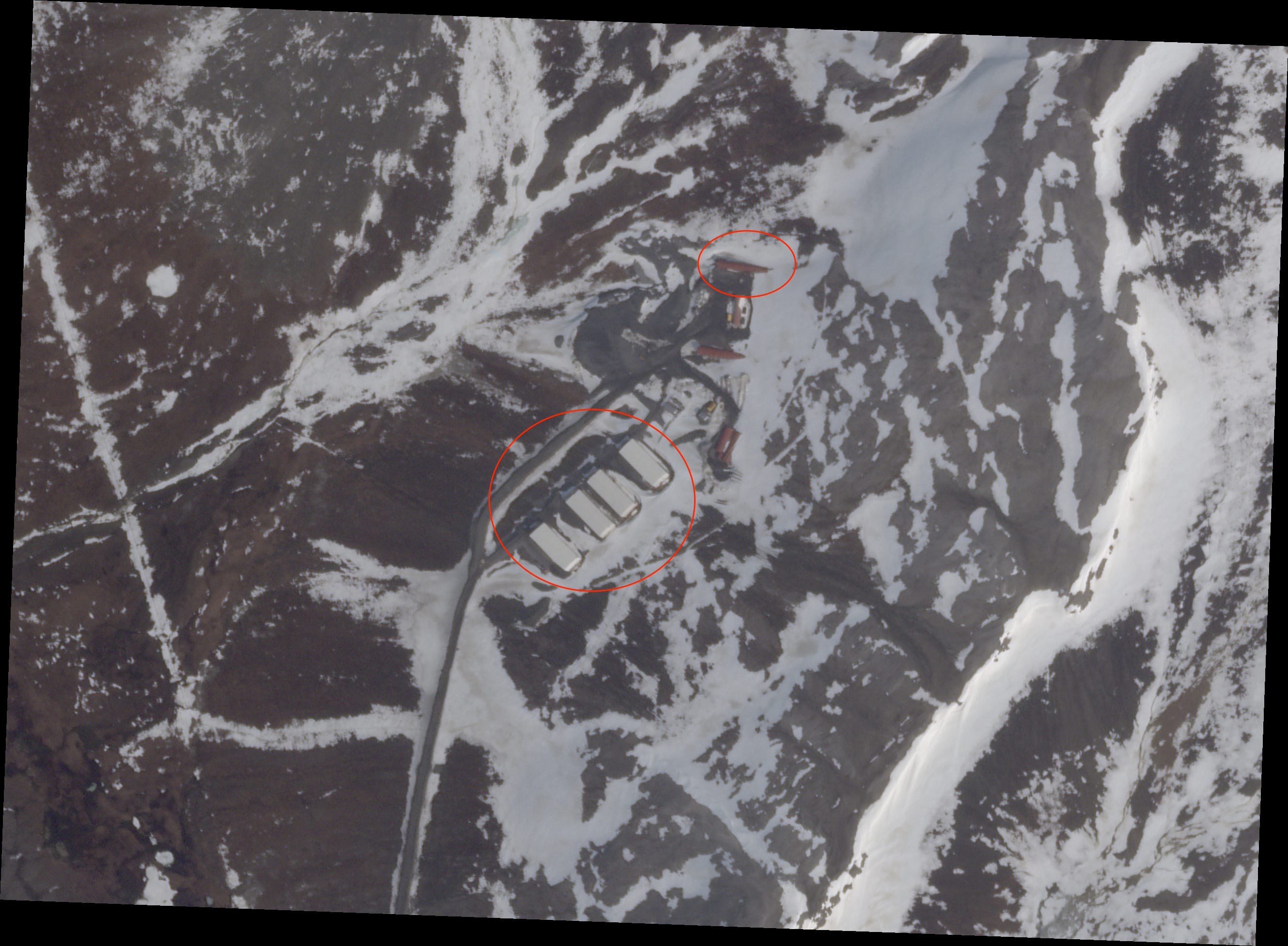 A modern satellite photo shows additional structures near the original tunnel entrance.