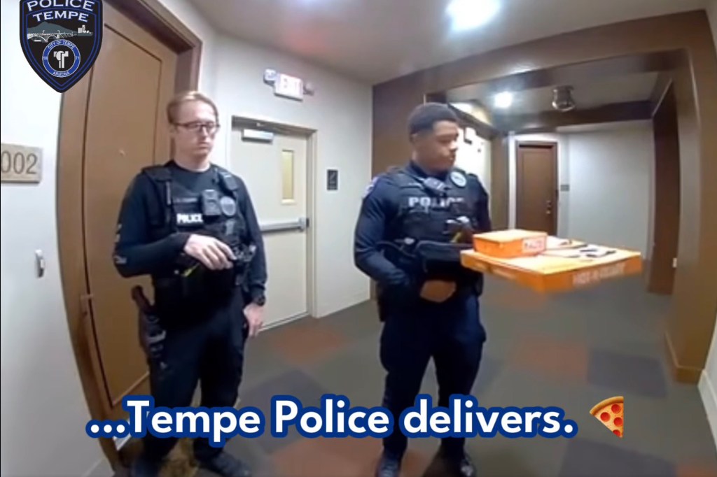 Two Tempe police officers delivering pizza.