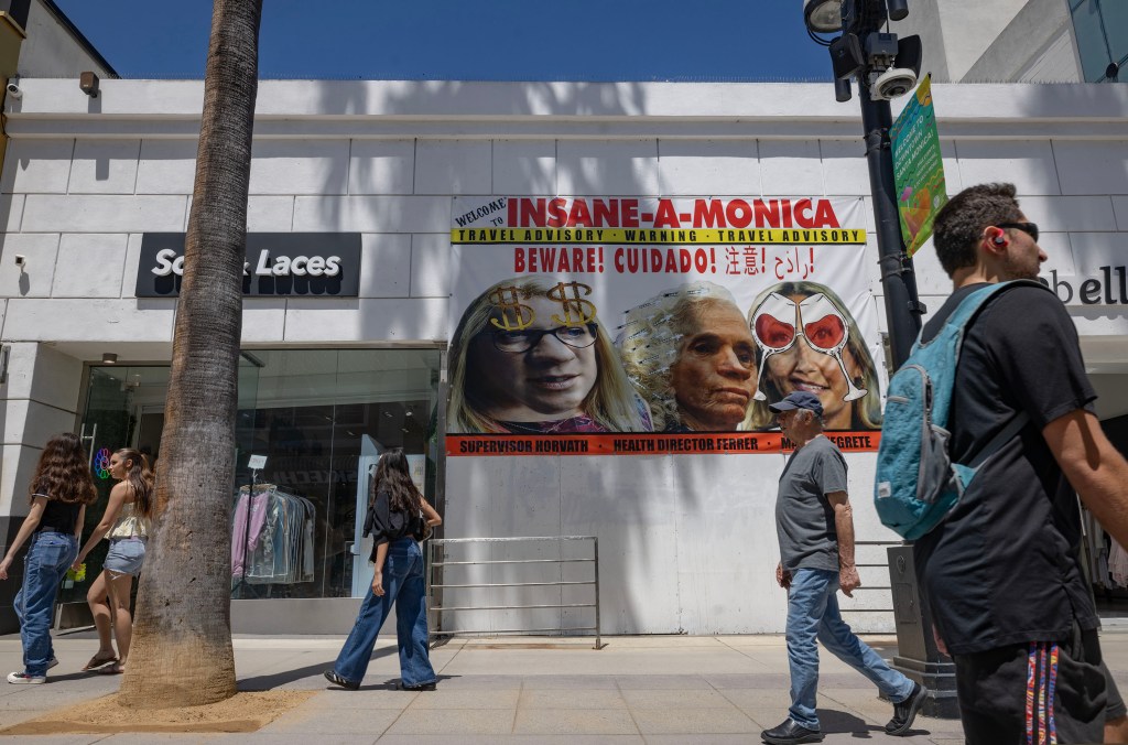 One of John Alle's buildings on Santa Monica's Third Street Promenade. The Santa Monica Coalition hung a sign blasting local politicians.