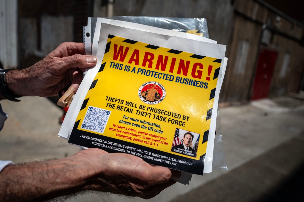 Signs distributed by District Attorney Nathan Hochman warning would-be troublemakers.
