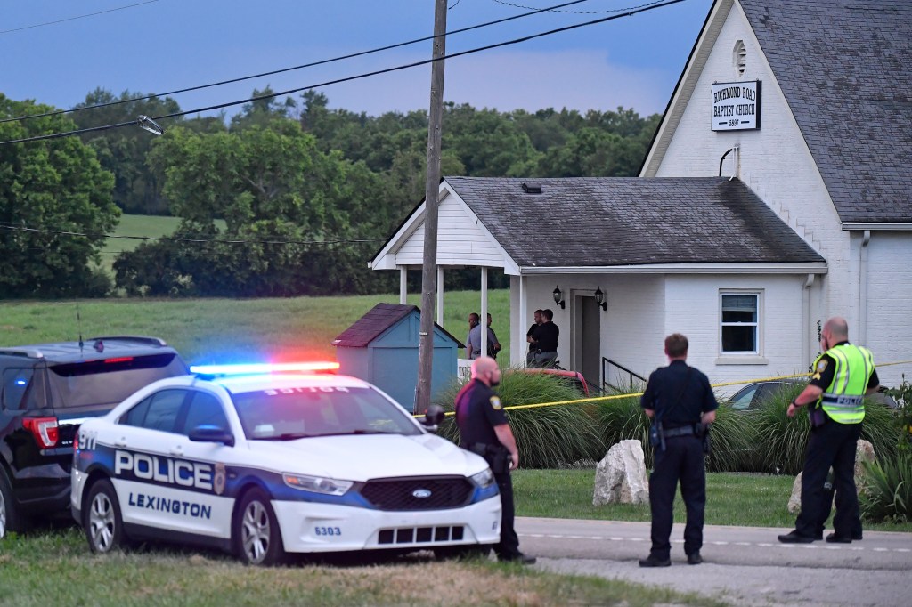 Police stand at the front of the Richmond Road Baptist Church as other officers maintain a perimeter following a shooting at the church in Lexington, Ky., Sunday, July 13, 2025. 