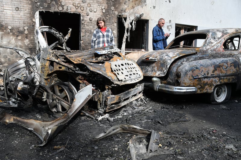 LVIV, UKRAINE - JULY 12: Locals stare on cars lying burned and wrecked at the site of a Russian drones' strike on the city's residential area on July 12, 2025 in Lviv, Ukraine. Overnight into July 12, the Russian army launched a combined strike on Ukrainian cities, using almost 600 drones and 26 missiles. In Lviv, the drones' attack resulted in damage to residential apartment buildings, two industrial enterprises, a preschool building, and dozens of cars. Nine people were injured, including two children. (Photo by Mykola Tys/Global Images Ukraine via Getty Images)