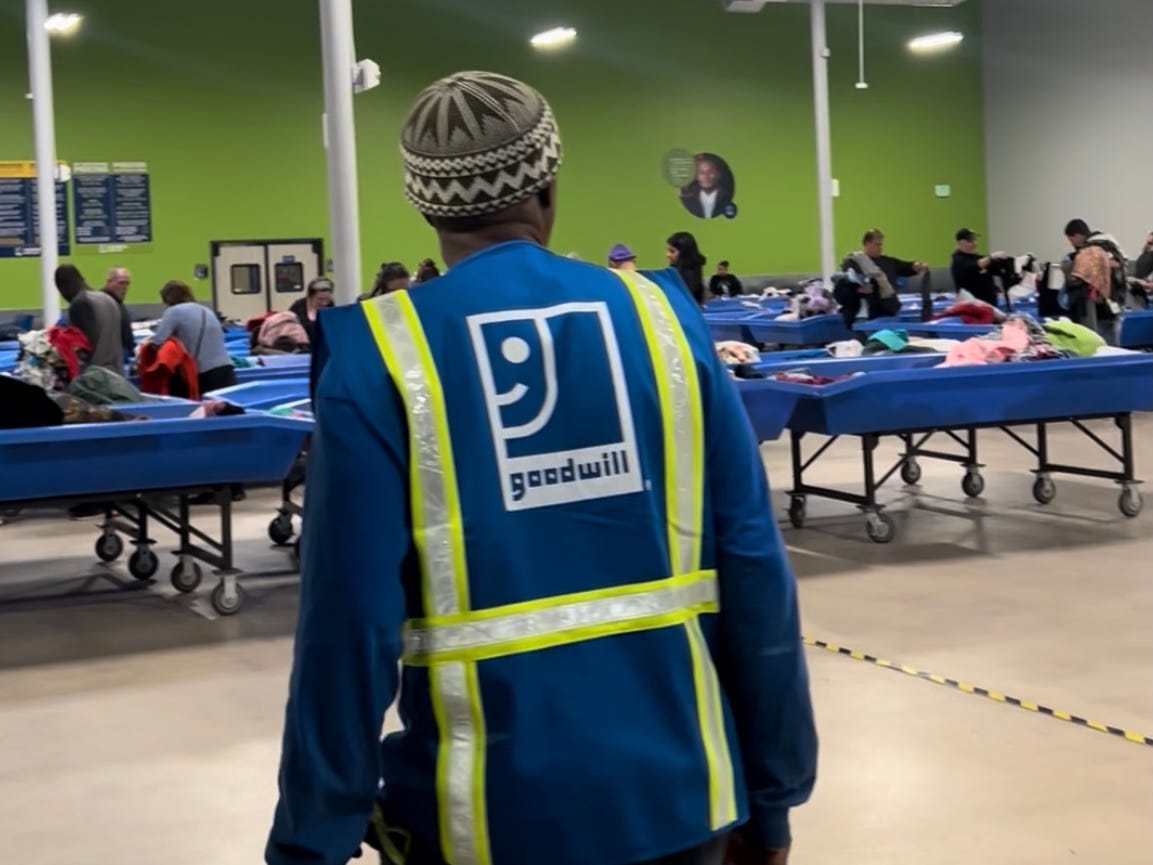 Goodwill blue bins filled with secondhand items in a warehouse
