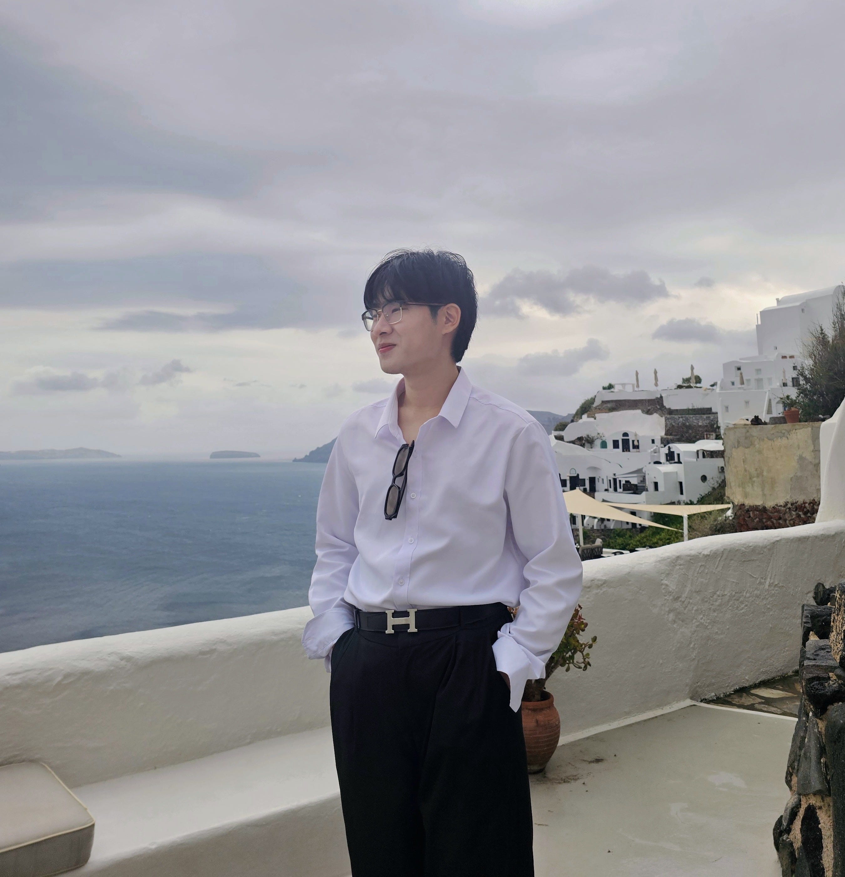 Jay Jung is standing in front of an ocean