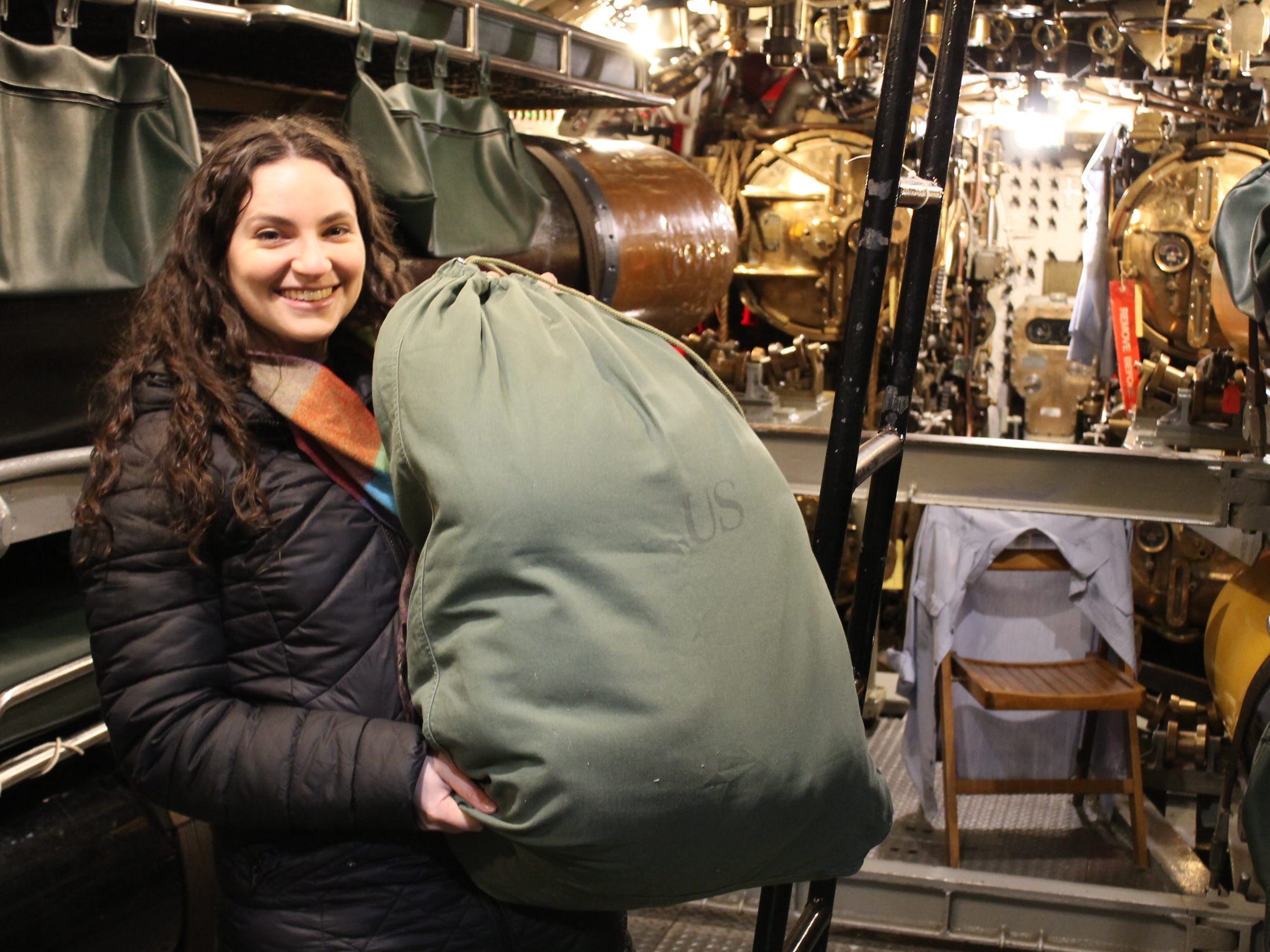 Talia Lakritz holds a seabag on the USS Cobia.