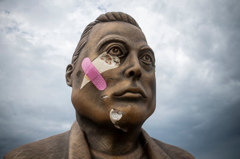 This photo taken on May 28, 2025 shows a damaged bust of Elon Musk with a plaque reading "Elon aka MemeLord by ElonRWA on BASE" outside Brownsville, Texas. (Photo by SERGIO FLORES / AFP) / RESTRICTED TO EDITORIAL USE - MANDATORY MENTION OF THE ARTIST UPON PUBLICATION - TO ILLUSTRATE THE EVENT AS SPECIFIED IN THE CAPTION (Photo by SERGIO FLORES/AFP via Getty Images)