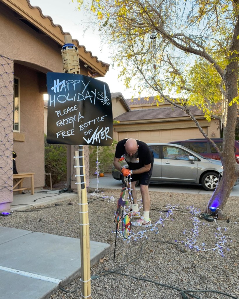 Martin decorates a sign advertising the free water.