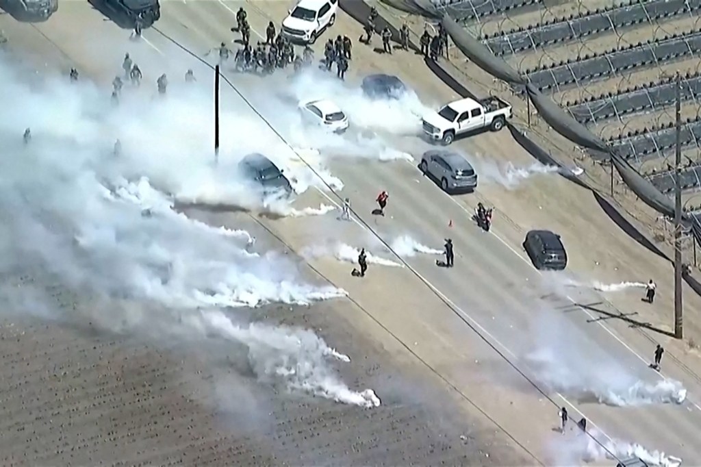 Tear gas billows from cannisters thrown by federal agents towards protesters, during an immigration raid on an agricultural facility in Camarillo, California, U.S. July 10, 2025