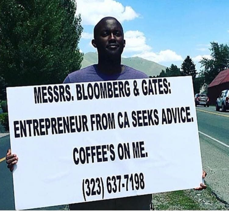 Dushime Gashugi holding a sign at the Sun Valley conference in 2017
