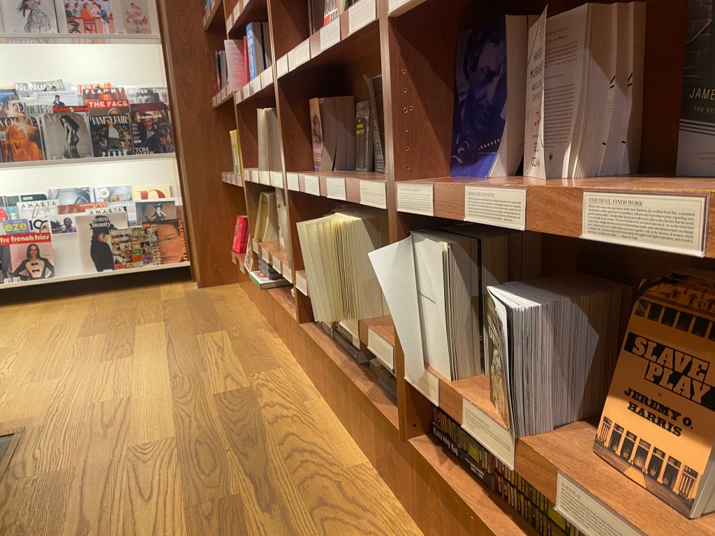 Books and magazines on shelves at a bookstore.