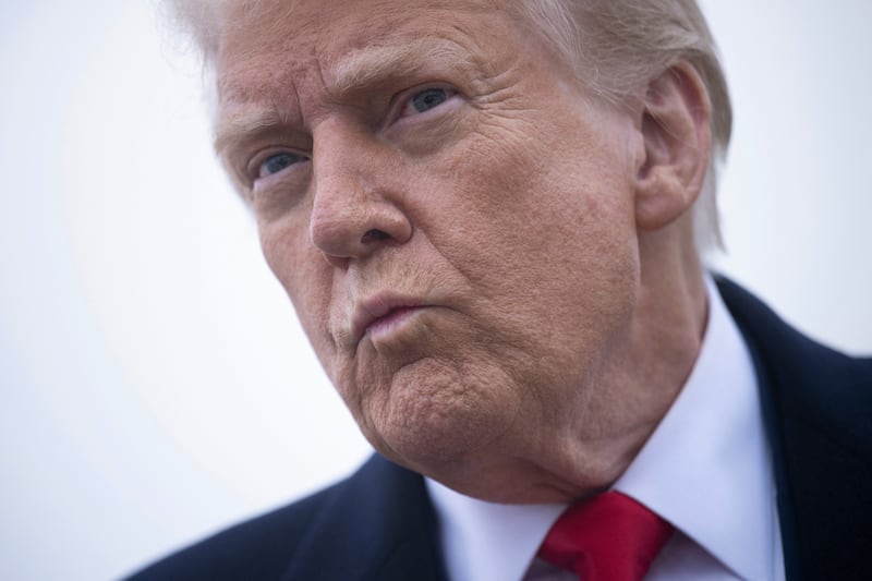 TOPSHOT - US President Donald Trump speaks to the press about the conflict in Ukraine before boarding Air Force One at Andrews Air Force Base March 14, 2025, in Maryland. Trump is spending the weekend at his Florida Mar-a-Lago resort. (Photo by Brendan Smialowski / AFP) (Photo by BRENDAN SMIALOWSKI/AFP via Getty Images)
