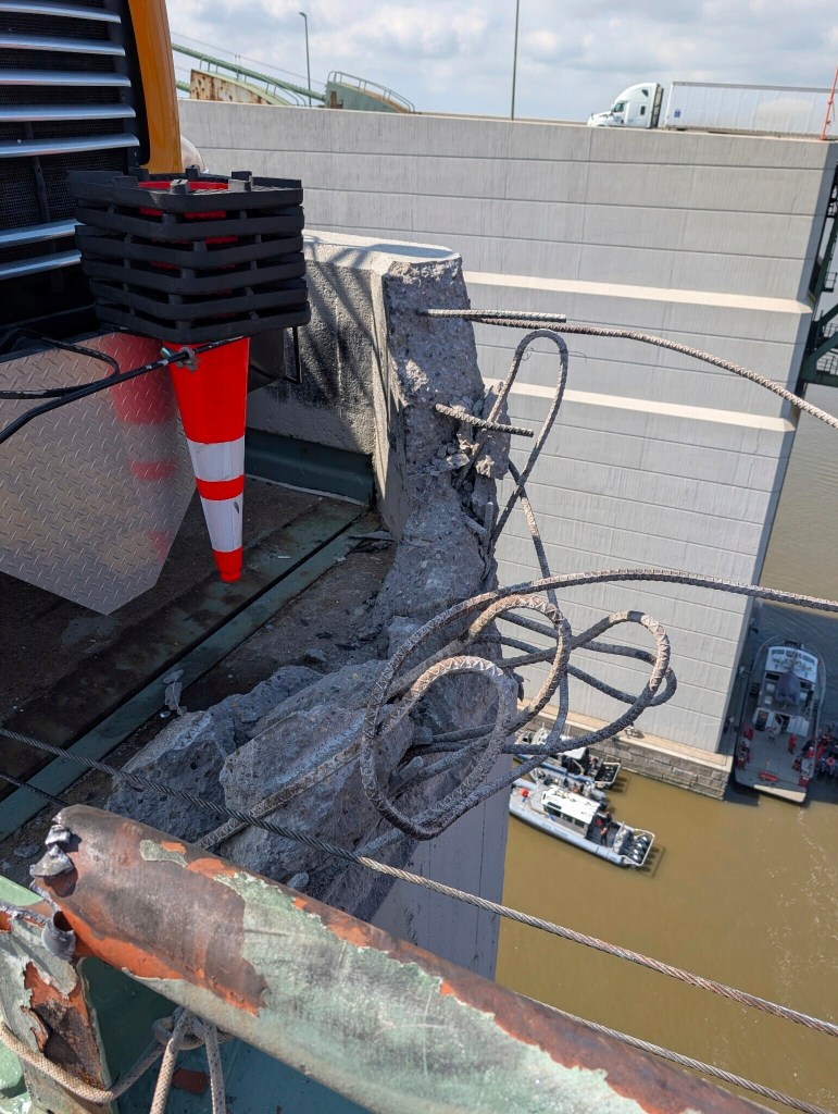 Damage to a bridge after a tractor-trailer crash.
