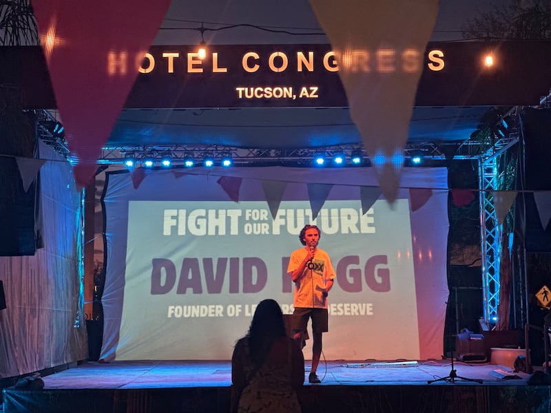 David Hogg speaking on stage at Deja Foxx's rally in Tucson.