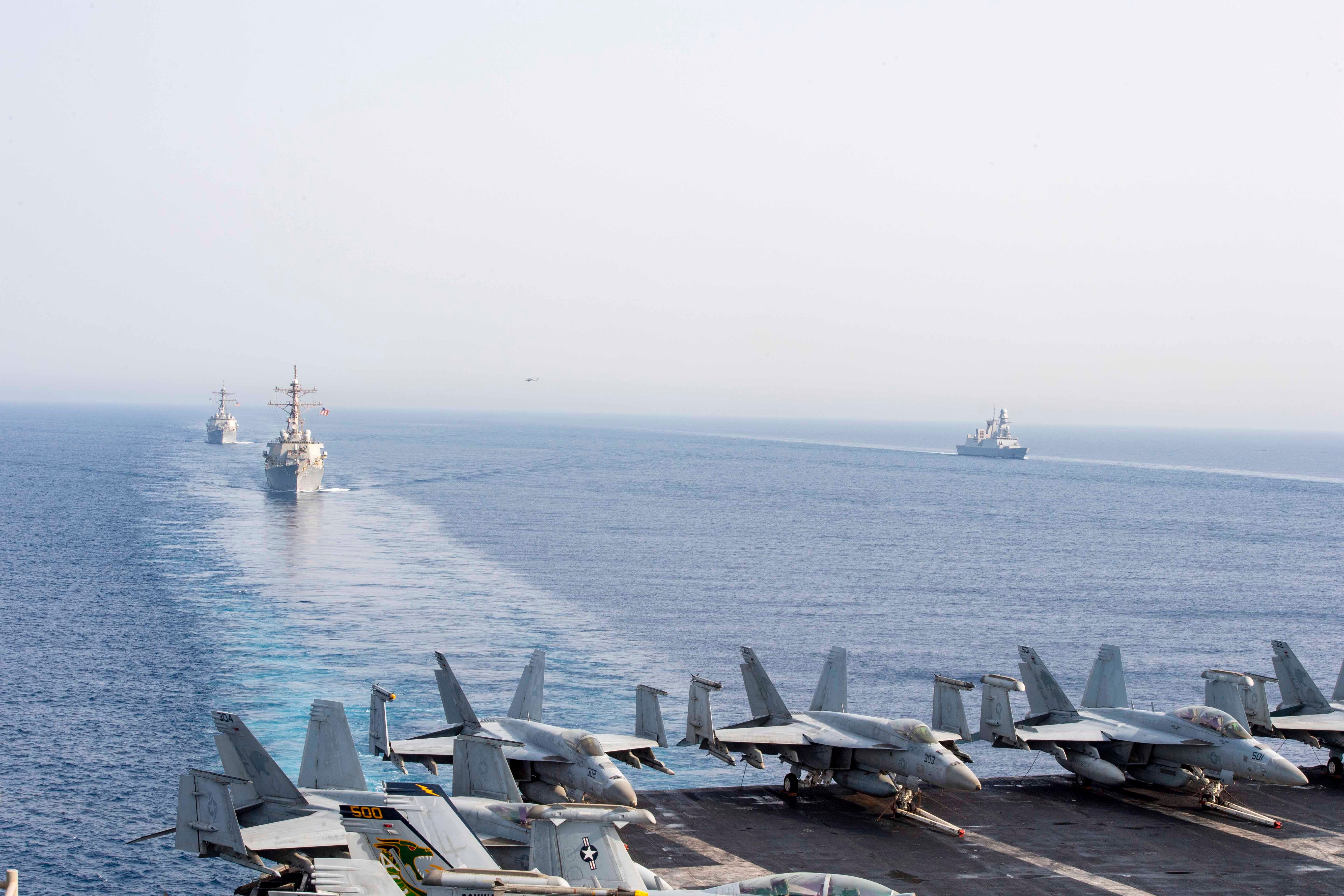 Components of the Dwight D. Eisenhower Carrier Group — the Nimitz-class aircraft carrier USS Dwight D. Eisenhower and Arleigh Burke-class guided-missile destroyers USS Laboon and USS Gravely — steam in formation with the Italian aircraft carrier ITS Cavour, the Carlo Bergamini-class frigate ITS Alpino, and the Horizon-class frigate FS Forbin in the Red Sea.