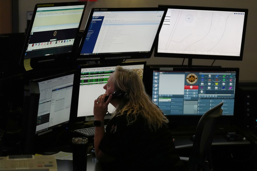 Dispatcher using computer system to answer 911 call.