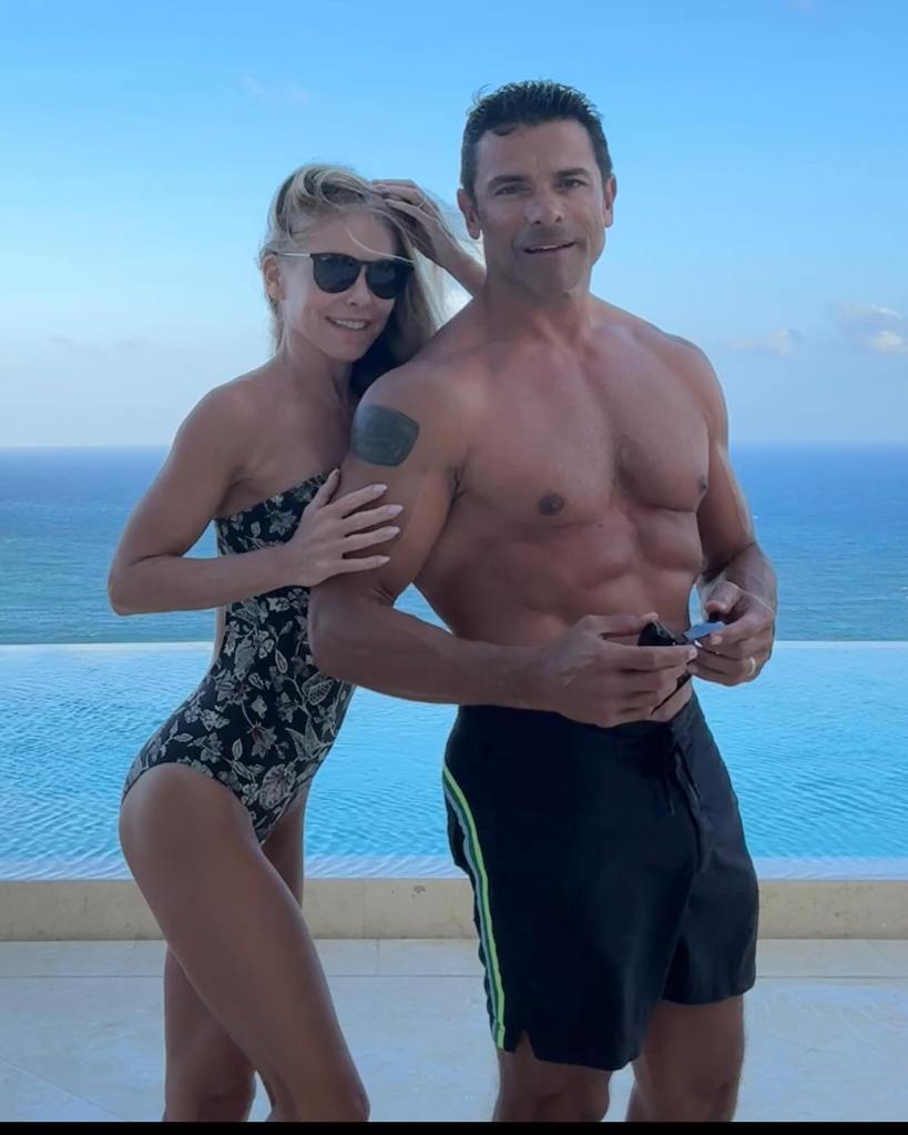 Kelly Ripa and Mark Consuelos by the pool. 