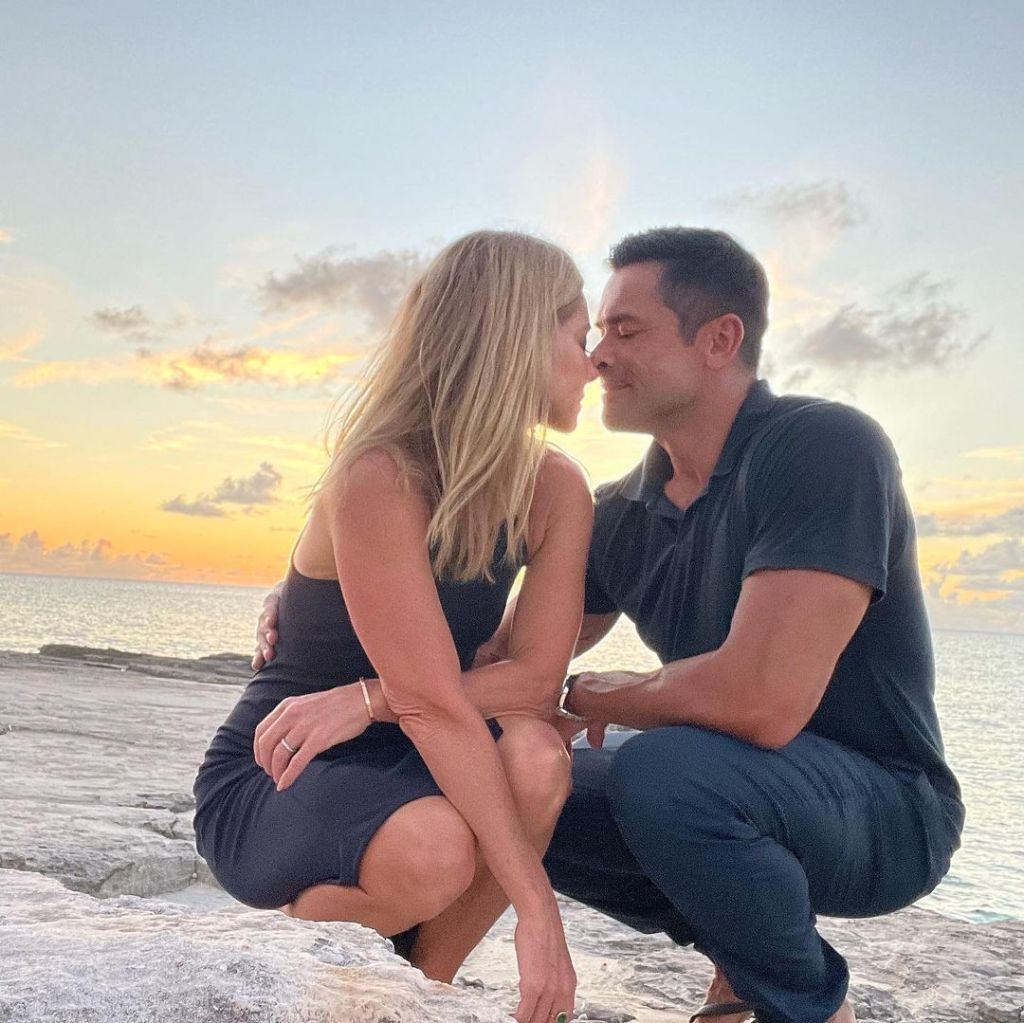 Kelly Ripa and Mark Consuelos on the beach. 
