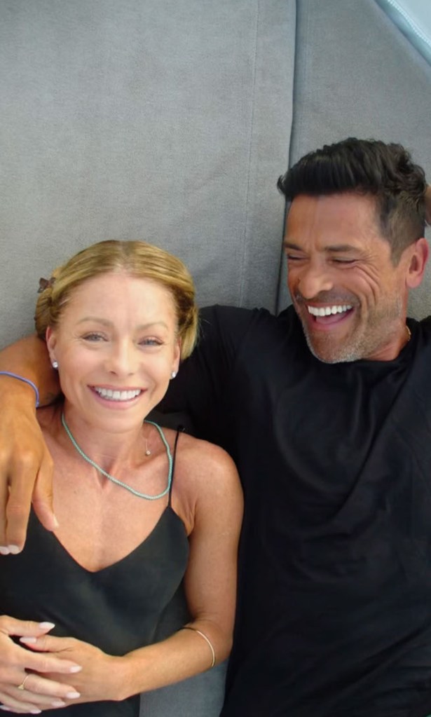 Kelly Ripa and Mark Consuelos cuddling. 