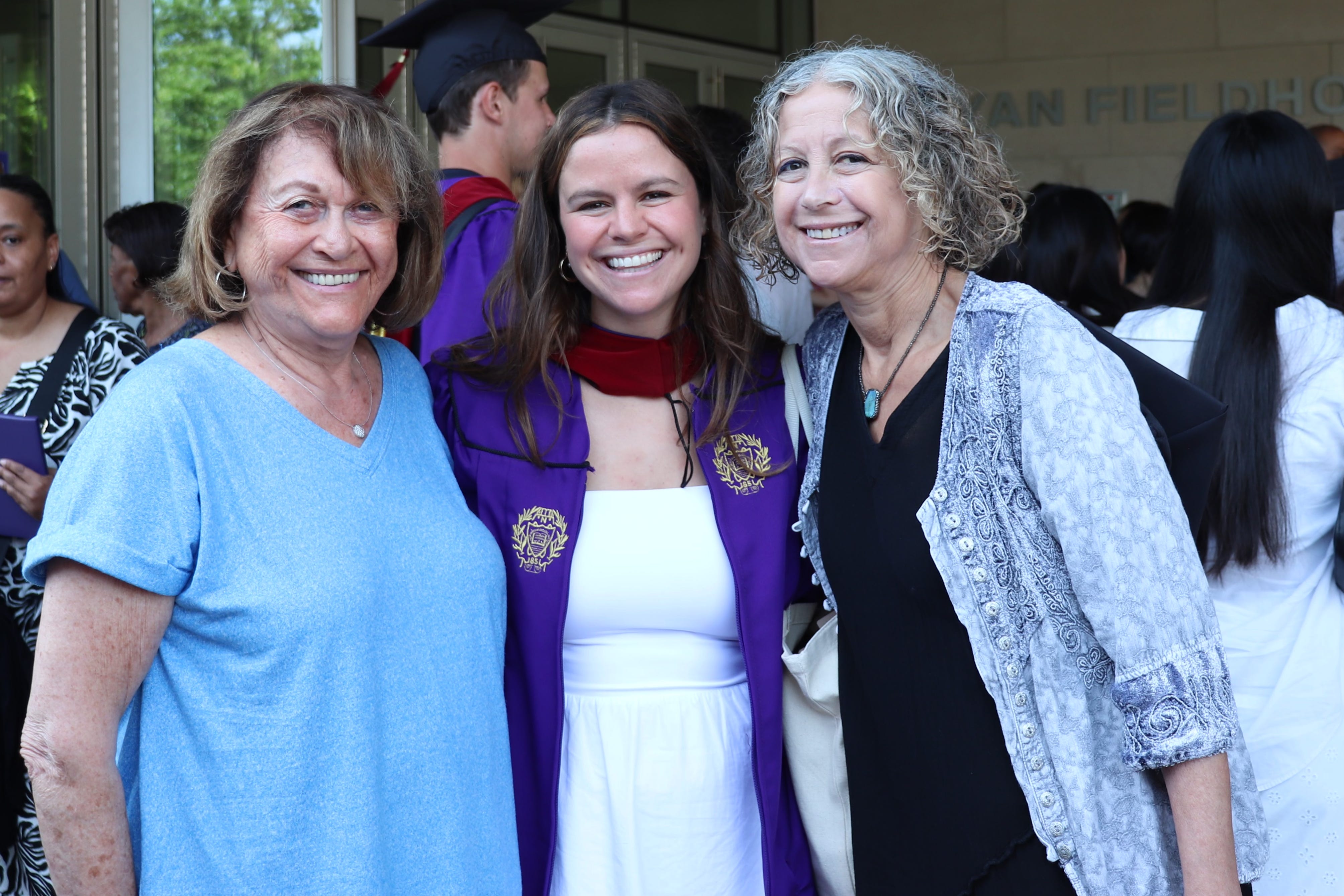Author with her mom, grandma smiling at the author's graduation