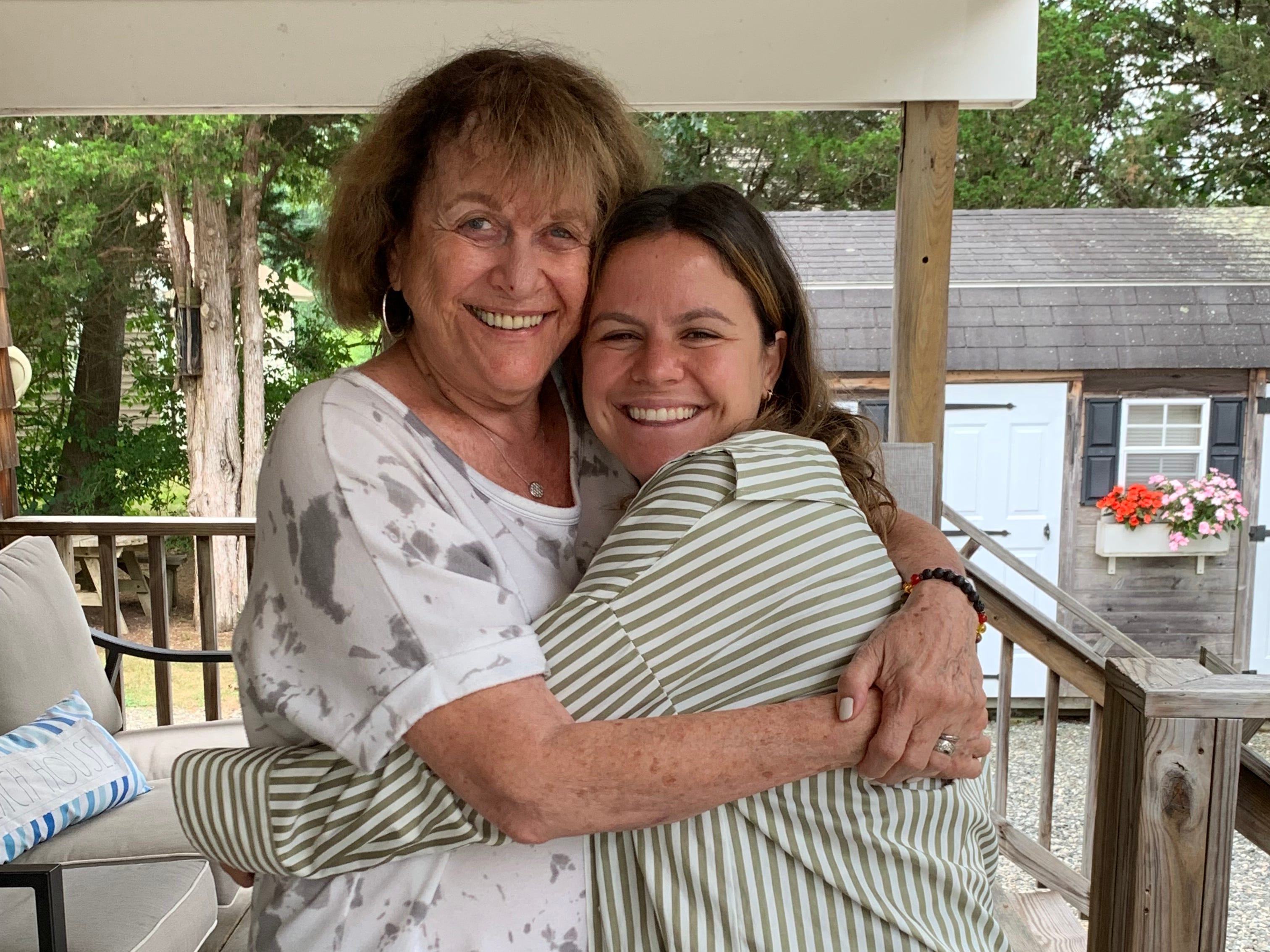 Author and her grandmother hugging on deck of a house in Rhode Island