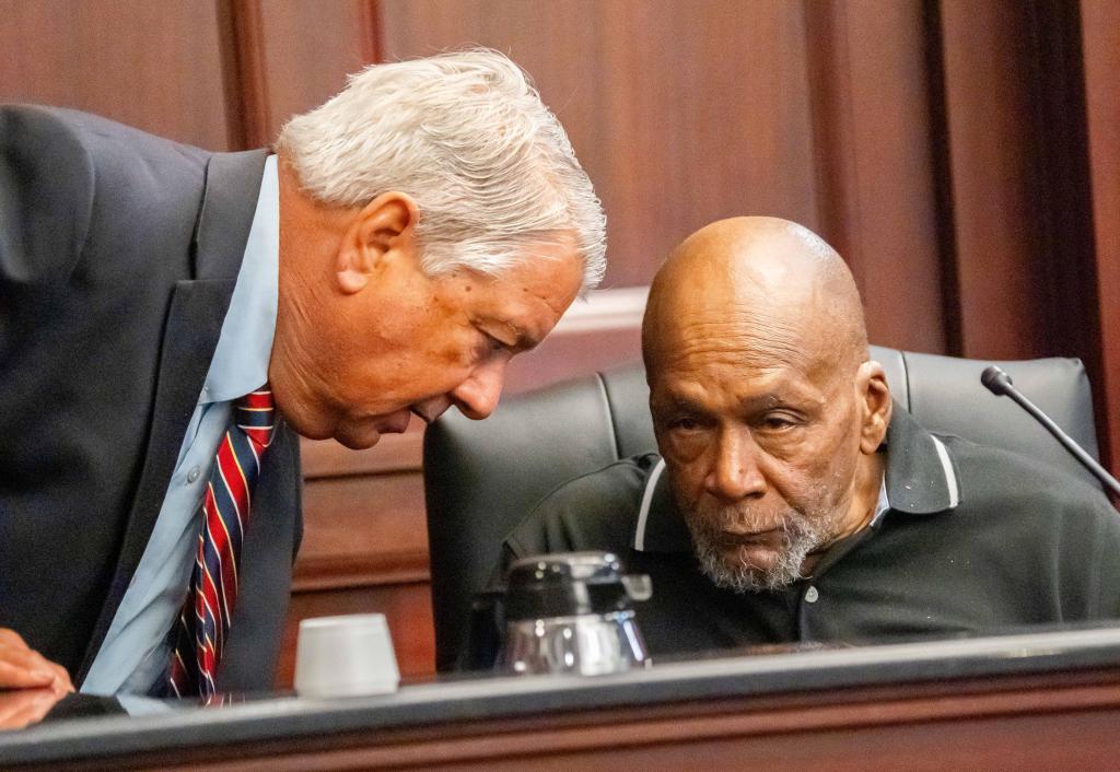 Attorney Donald Mayer speaking with his client Henry Edwards.