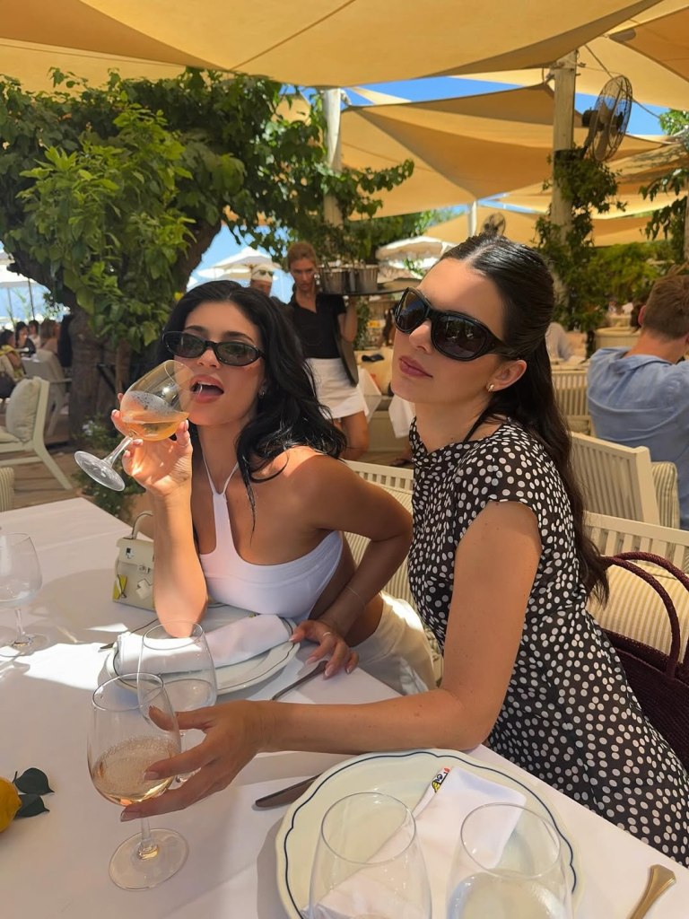 Kendall and Kylie Jenner drinking wine.