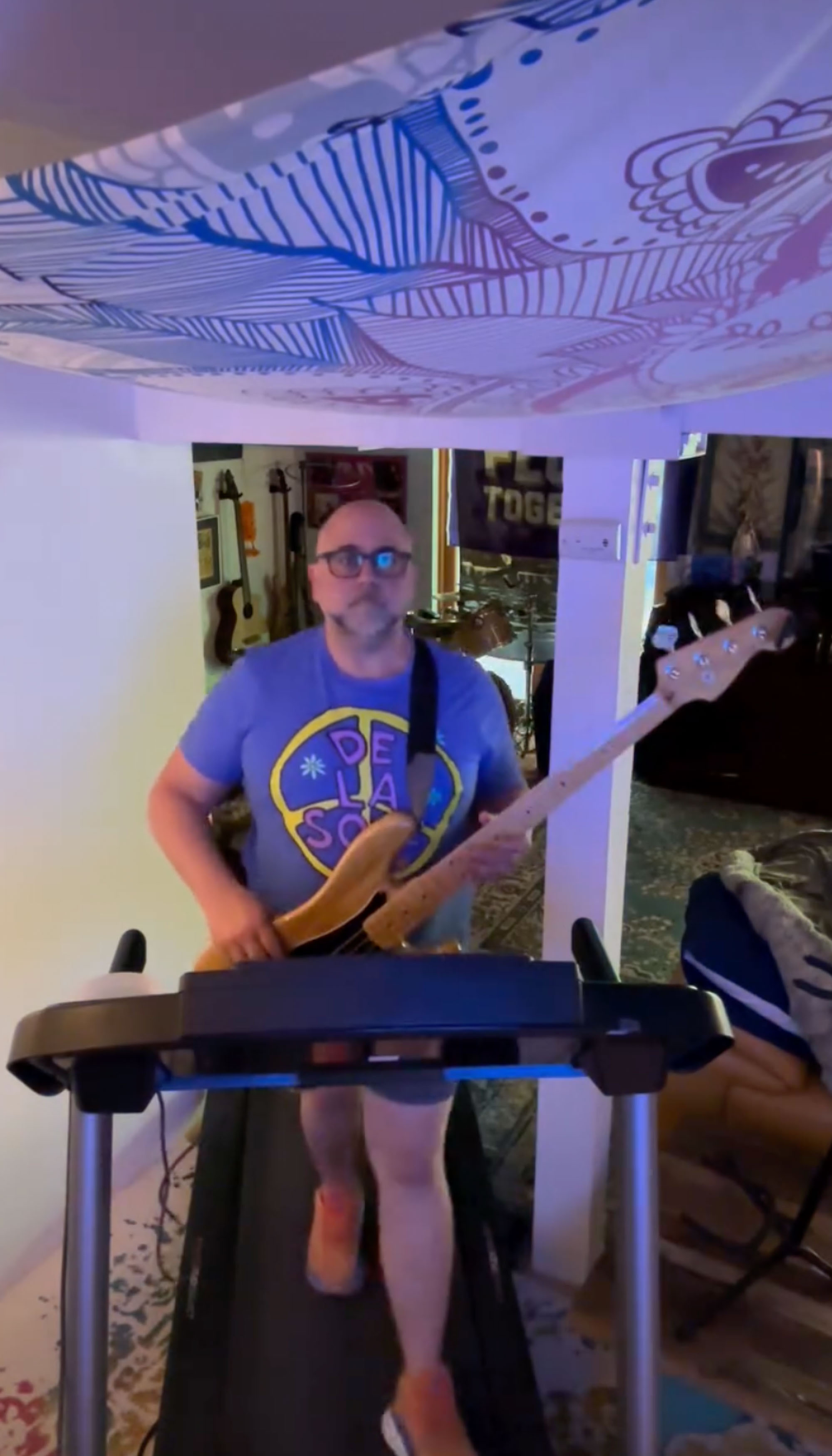 Duff Goldman plays guitar on a treadmill. 