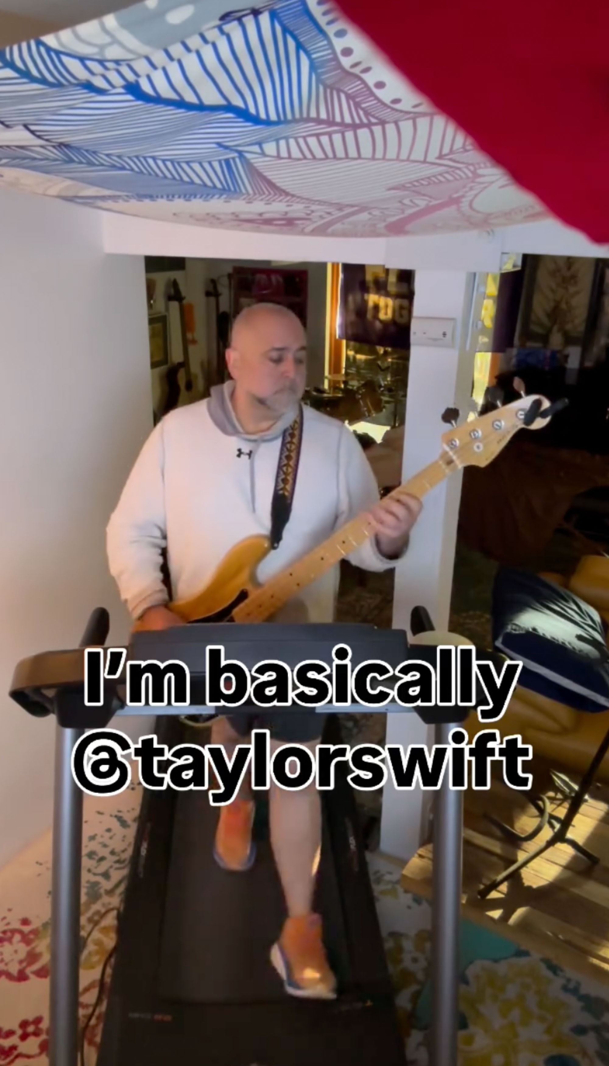 Duff Goldman walking on a treadmill with a guitar. 