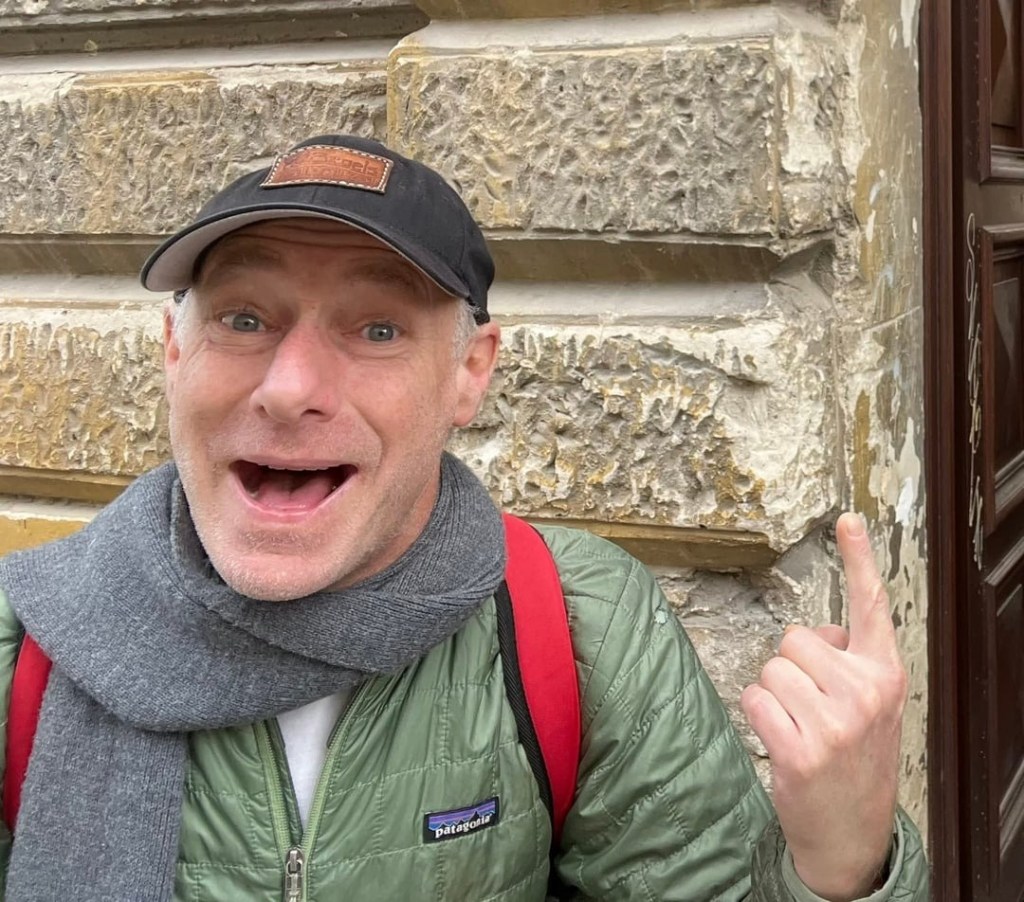 Man pointing at a wall.